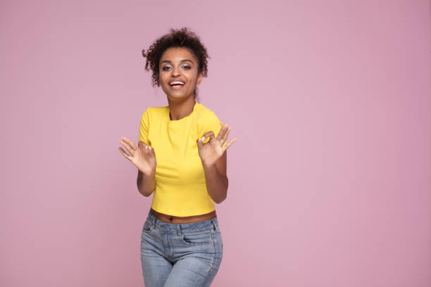 istock Excited smiling afro girl posing on pink. 1034373674
