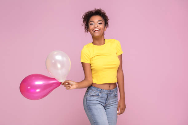 istock Excited smiling afro girl posing on pink. 1034375874