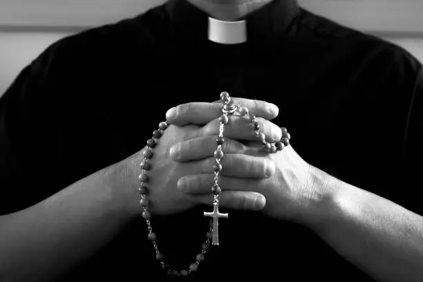 Photo of Priest with rosary beads