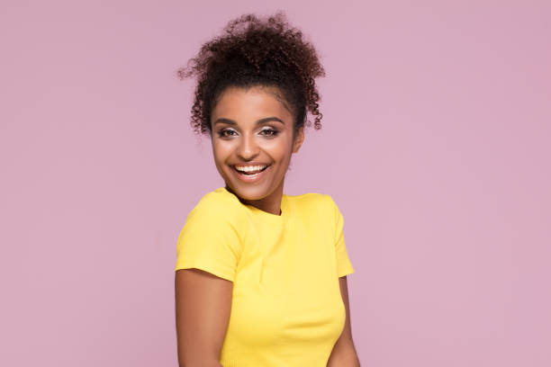 istock Excited smiling afro girl posing on pink. 1034376000