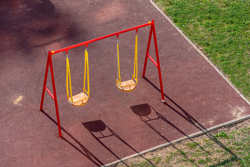 Empty swings on the children playground. Back to school concept