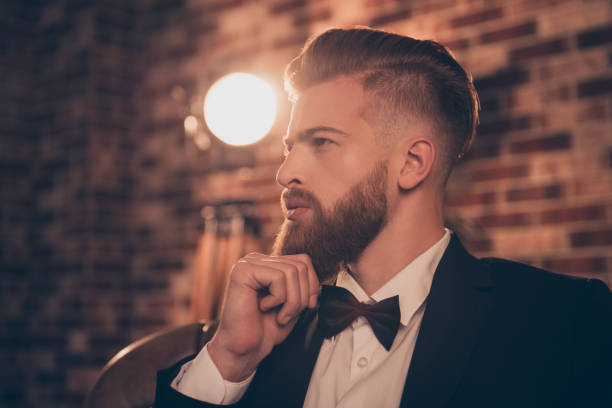 istock Dandy brutal classic style project start-up model lifestyle rich wealthy leisure freelancer worker concept. Half-faced view portrait of handsome classy posh virile masculine pensive man touching chin 1034387186