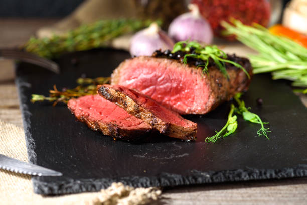istock rare steak black angus garlic knife fork 1034387284