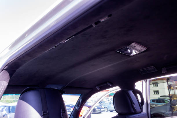 istock The ceiling of the SUV car pulled by black Alcantara material in the workshop for tuning and styling the interior 1034391620