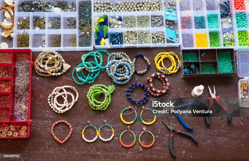 Colorful beads on wooden table Jewelry, Wire, Workshop, Brazil, Bead Jewelry Stock Photo