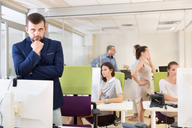 istock Pensive businessman in coworking space 1034394044