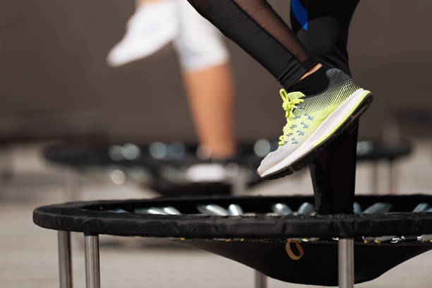 mujeres fitness saltando en camas elásticas pequeñas - trampolín artículos deportivos fotografías e imágenes de stock