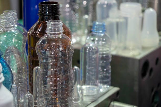 istock The various type of plastic bottle product and preform material with injection mold background. 1034395188
