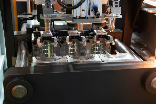 istock The  preform shape in the blowing mold  for plastic bottles manufacturing process at the drinking factory. 1034395240