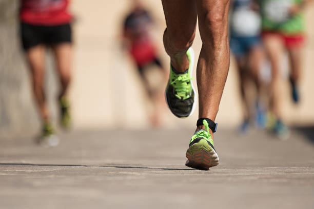 istock Marathon runners running on city road 1034395246