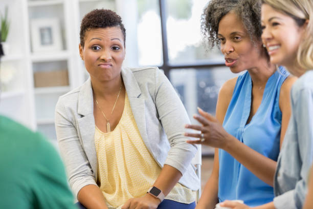 istock Mature woman talks during support group meeting 1034402120
