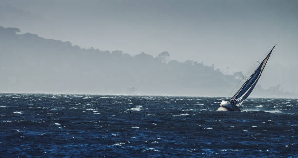 sailing boat in a gale with huge wind - san francisco county bridge california fog imagens e fotografias de stock