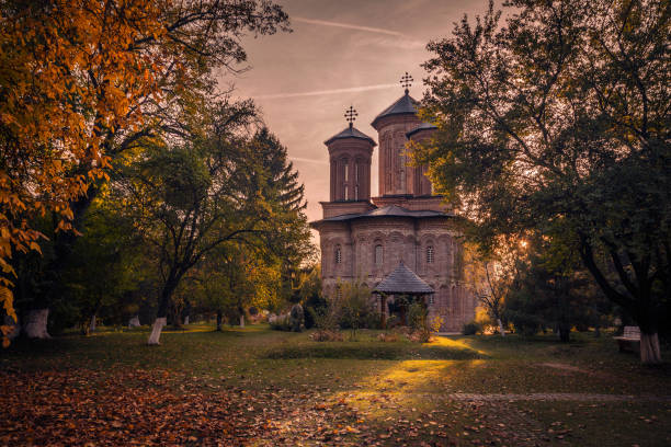 Beautiful architecture shot with an old monastery in a forest at sunset stock photo