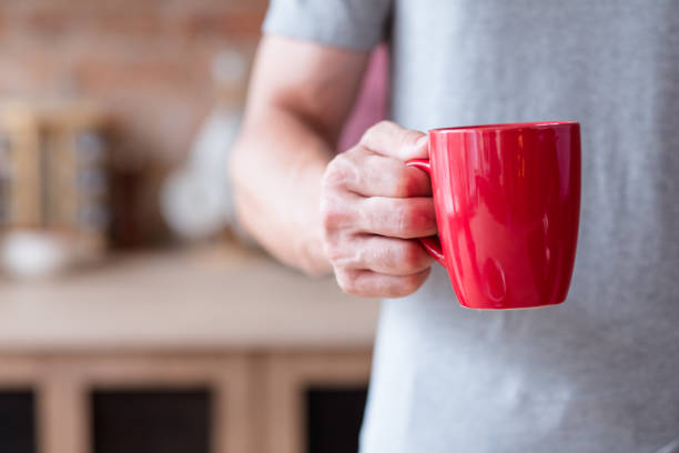 istock morning hot beverage breakfast man hold red mug 1034411610