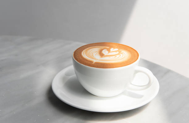 istock latte or Cappuccino with frothy foam, coffee cup top view on table in cafe. 1034413824