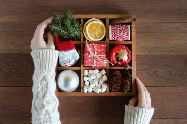 istock Female hands hold the wooden box with Christmas objects 1034418102