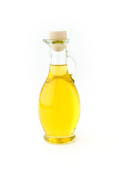 istock Olive Oil in a Glass Bottle on White 1034418106