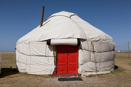 Yurt with red door at Song Kul lake in Kyrgyzstan