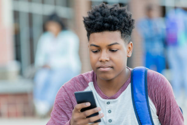 istock Teenage boy reading text 1034421546
