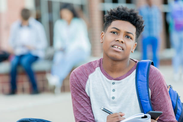istock Teenage boy finishes homework before school 1034421584