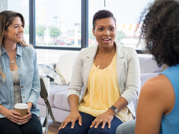 istock Mid adult woman enjoys supportive counseling group 1034424592