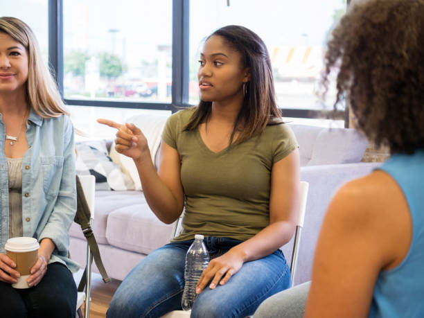istock Young woman shares advice with group therapy member 1034424602