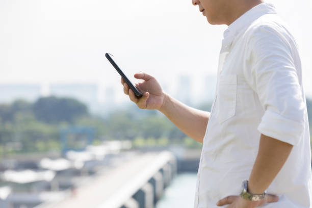 istock Unrecognizable businessman uses mobile app outdoors 1034426692