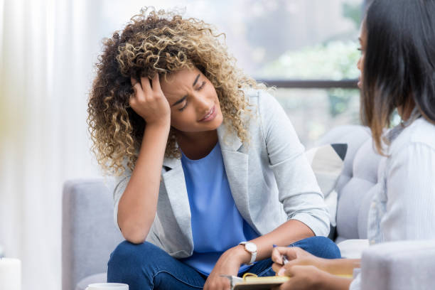 istock Upset young woman discussed issues with mental health professional 1034426822