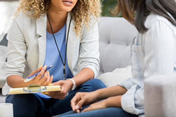 istock Counselor talks with female patient 1034426828
