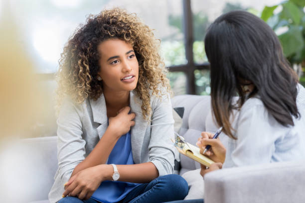 istock Vulnerable woman talks with counselor 1034426834