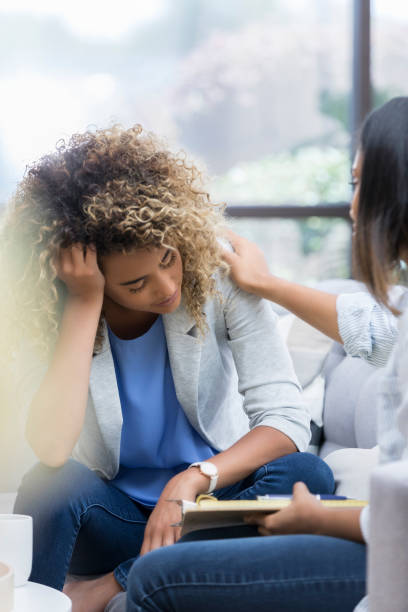 istock Female counselor comforts female patient 1034426840
