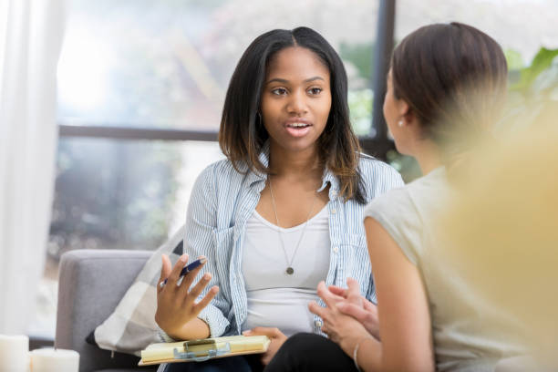 istock Serious counselor advises young woman 1034426842