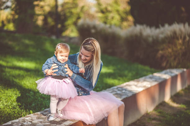 Happy Mother With Her Little Daughter Both Dressed In Tutu stock photo