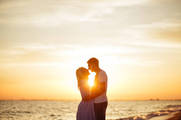 istock Young happy couple on seashore. 1034427410