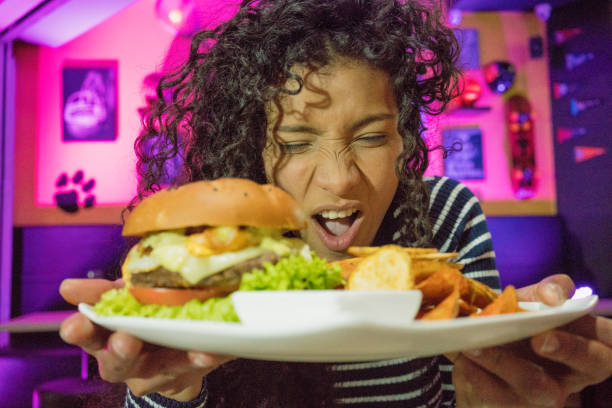 istock Amazed woman with a hamburger 1034428262