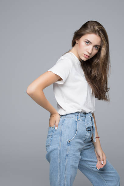 istock Young happy woman possing over gray background 1034428410