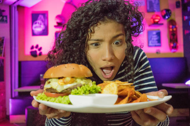 Amazed woman with a hamburger
