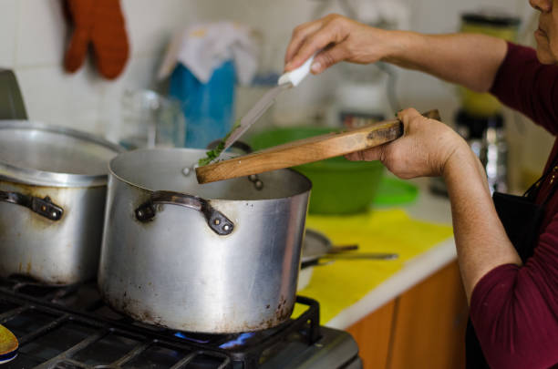 istock Hand of a woman adding ingredients to the pot 1034432024