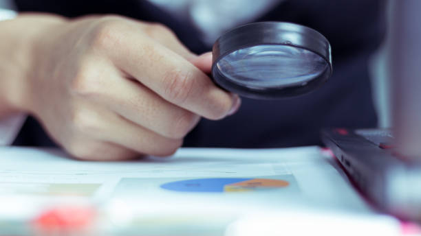 istock Businessmen use a magnifying glass to analyze the company's data and statistics from the chart. 1034434354
