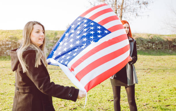 istock Two girls holding USA flag 1034434374