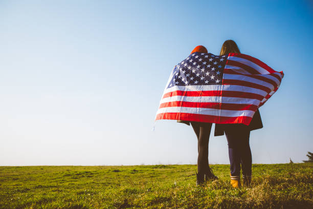 istock Two girls holding USA flag 1034434564