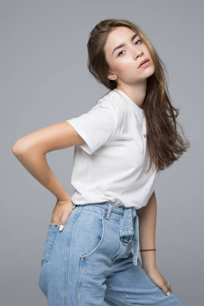 istock Young happy woman possing over gray background 1034435556