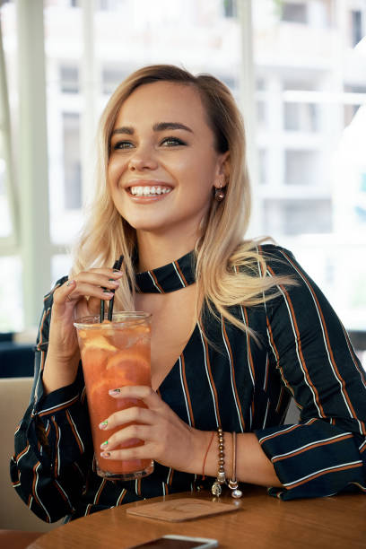 istock Young woman having good time while sitting in a modern cafe 1034435700