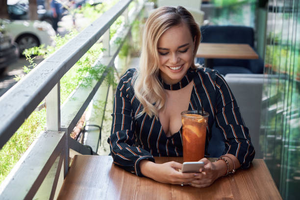 istock Adorable blond woman using smartphone sitting on the terrace 1034435716
