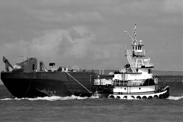 istock tugboat moving a barge background 1034437978