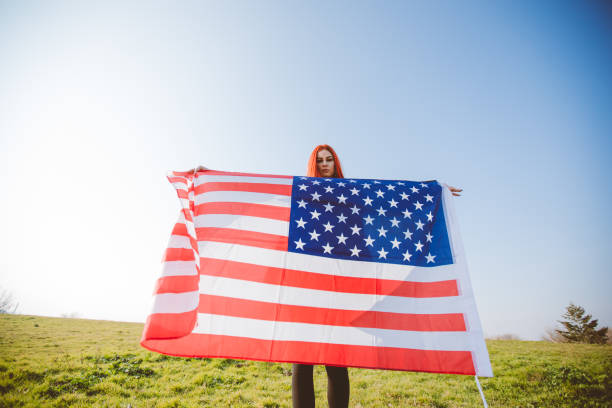istock Woman spreading USA flag 1034442110
