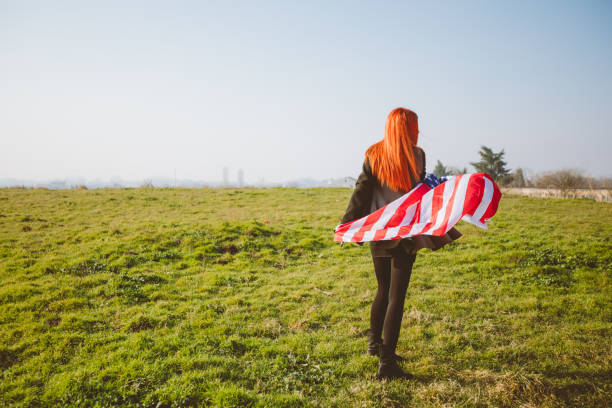 istock Woman waving USA flag 1034458318