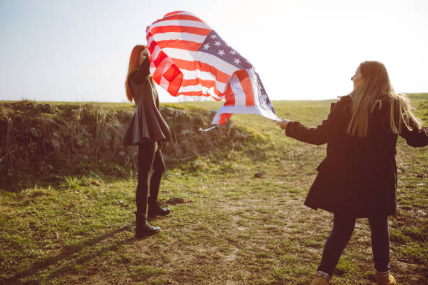 istock Two girls holding USA flag 1034458372