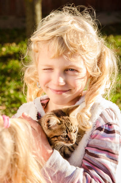 istock smiling girl with cat 1034461102