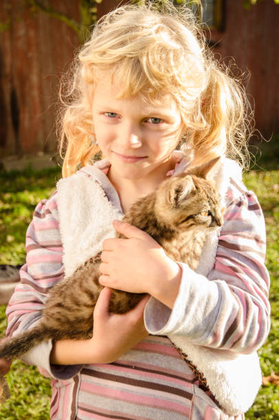 istock smiling girl with cat 1034461164